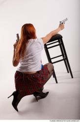 Woman Adult Average White Fighting with gun Kneeling poses Casual